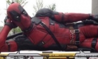 The coquettish superhero is lying on the strange and huge "Deadpool" statue of the "Deadpool" shocke